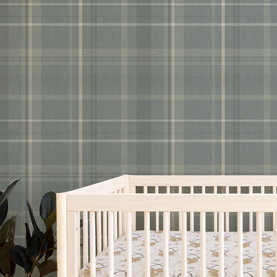 Nursery room with a white crib and plaid wall paper