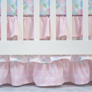 Crib with pink floral and polka dot bedding