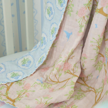 Floral crib sheet draped over a crib with a white background