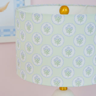Lamp with floral patterned shade against a pink background