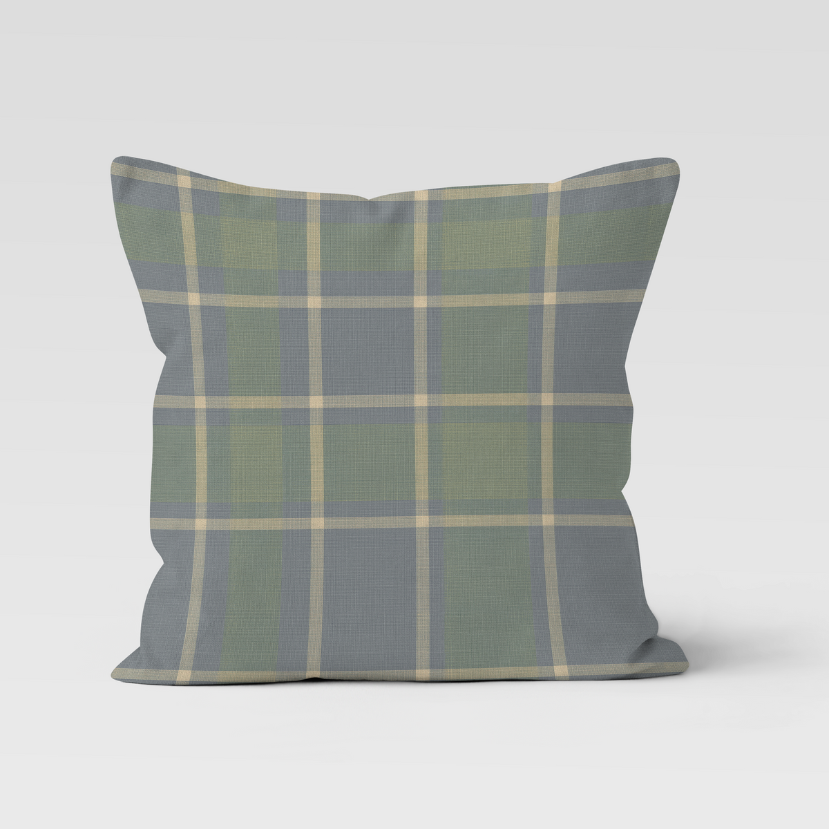 Plaid pillow with green and gray pattern on a white background