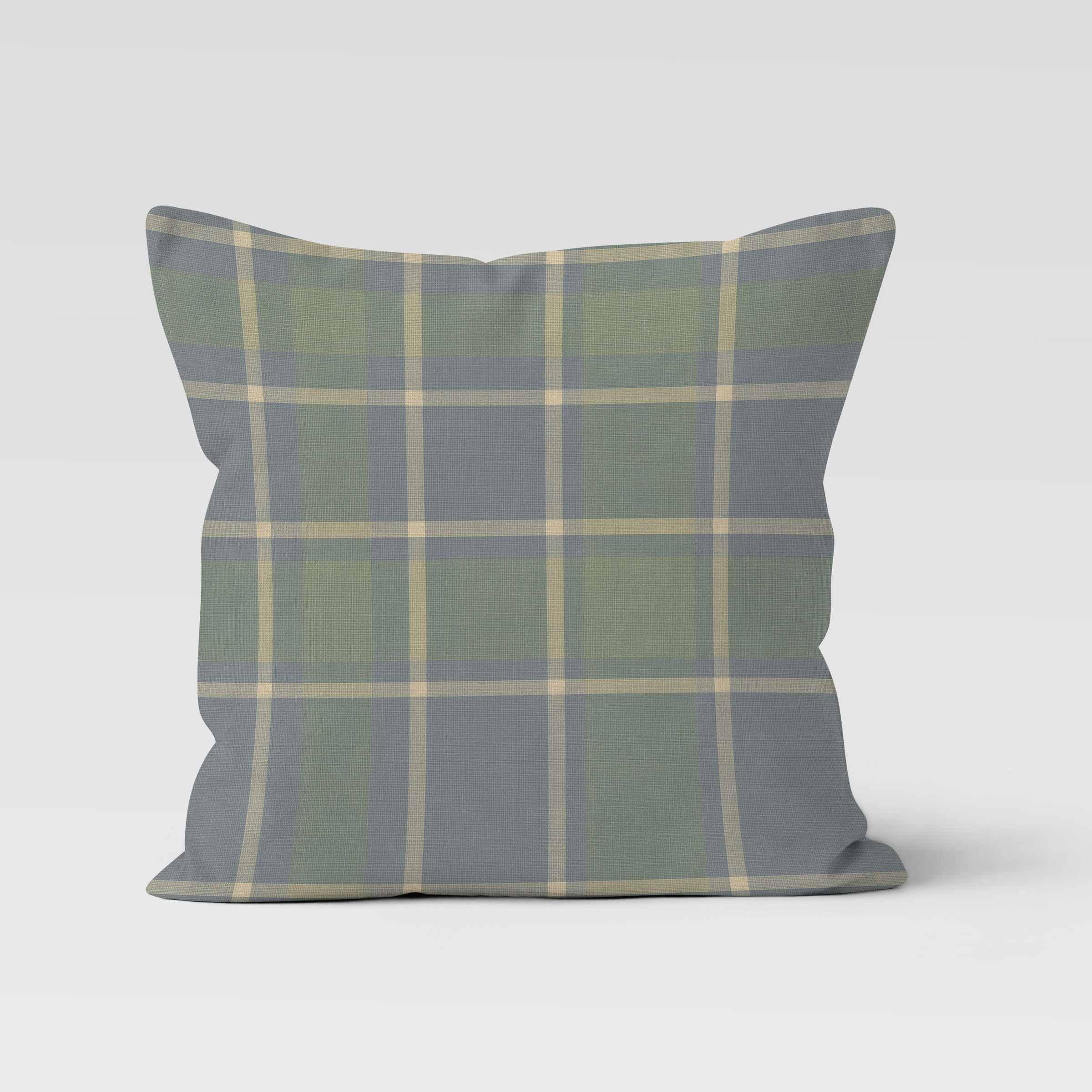 Plaid pillow with green and gray pattern on a white background
