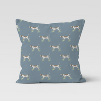 Blue pillow with dog pattern on a light gray background
