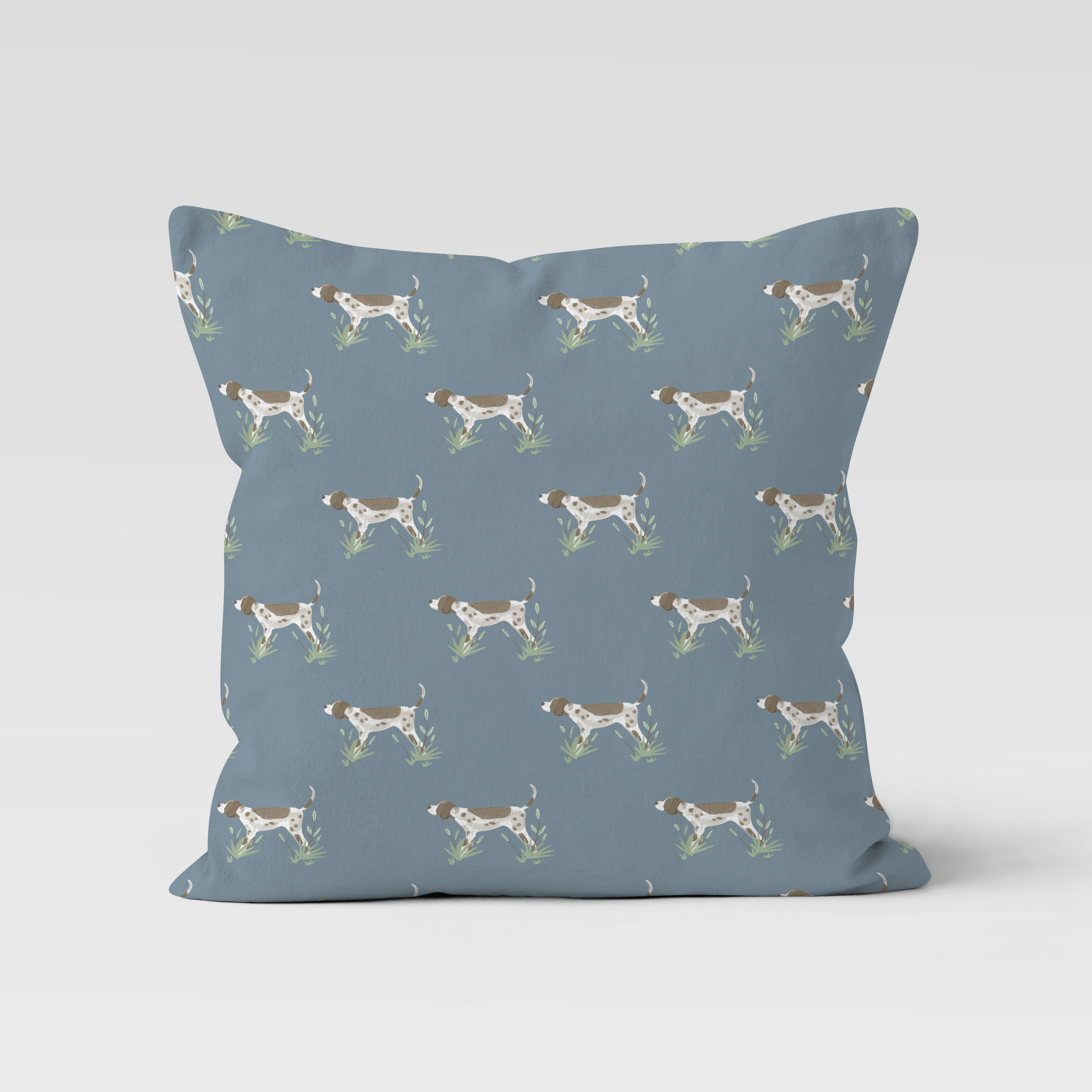 Blue pillow with dog pattern on a light gray background