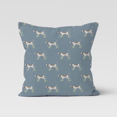 Blue pillow with dog pattern on a light gray background