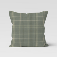Green plaid pillow on a white background