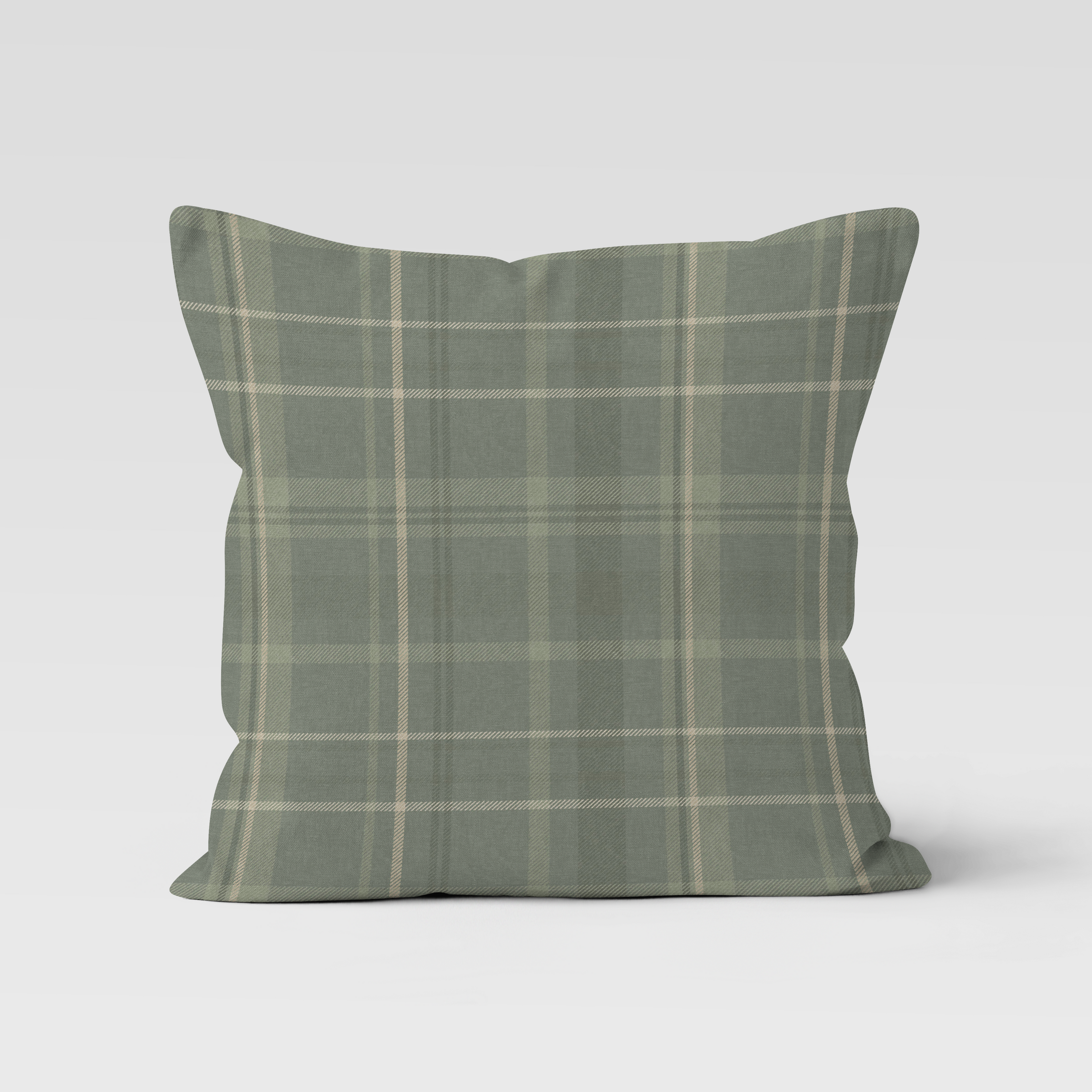Green plaid pillow on a white background