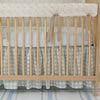 A crib bedding set with a duckling design, including a personalized blanket with the name 'William', displayed in a nursery room.