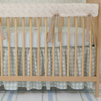A crib bedding set with a duckling design, including a personalized blanket with the name 'William', displayed in a nursery room.