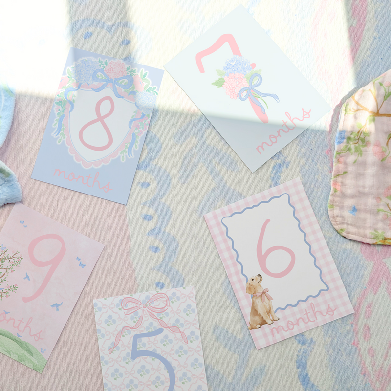 Baby milestone cards with numbers on a soft fabric background